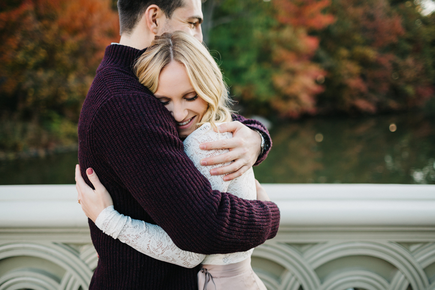 Colorful fall engagement session at sunrise on Bow Bridge in Central Park