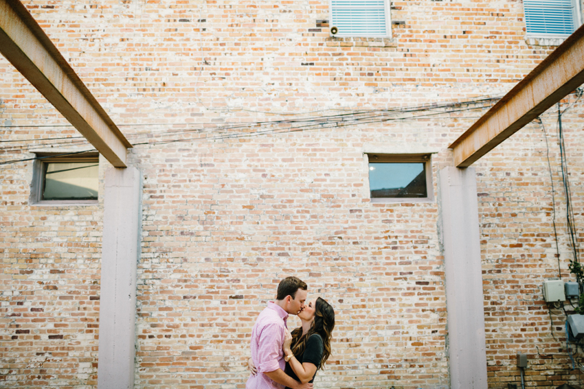 Urban engagement photos in front of a brick wall in downtown Tampa