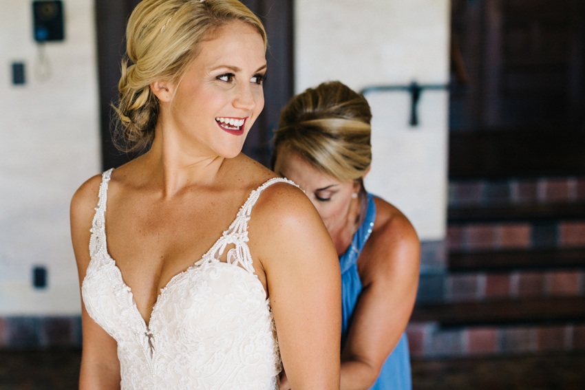 candid moment as the bride gets ready for her Powel Crosley wedding