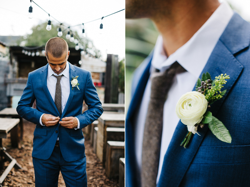groom wearing a navy jcrew suit with a brown tweed tie and ranunculus boutonniere