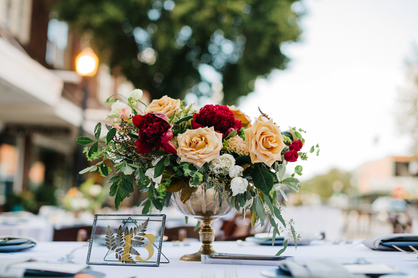 Lush floral centerpieces in vintage gold compotes