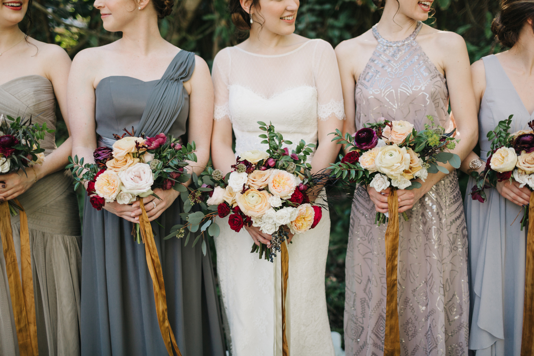 lush romantic wedding bouquets with burgundy, blush, and gold tied with mustard and ivory loose ribbon