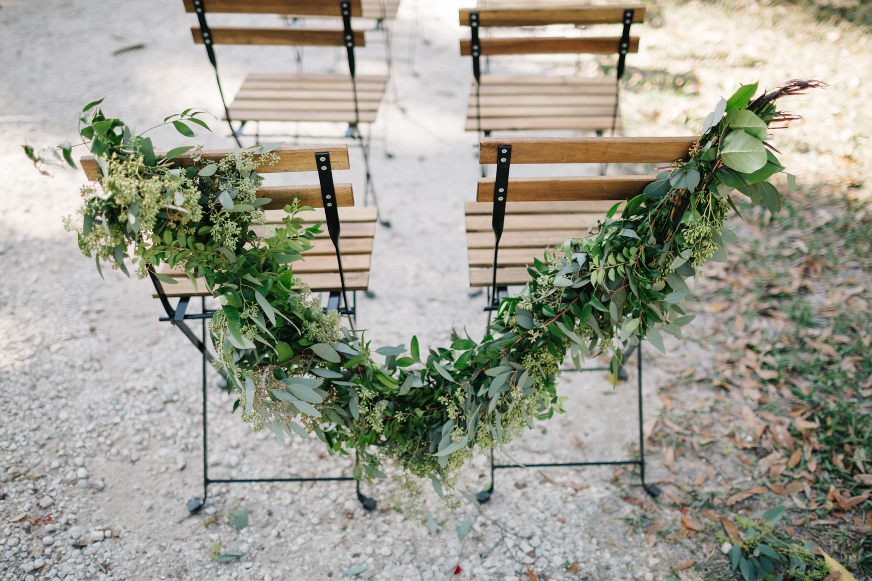 a garland of greenery around the ceremony chairs