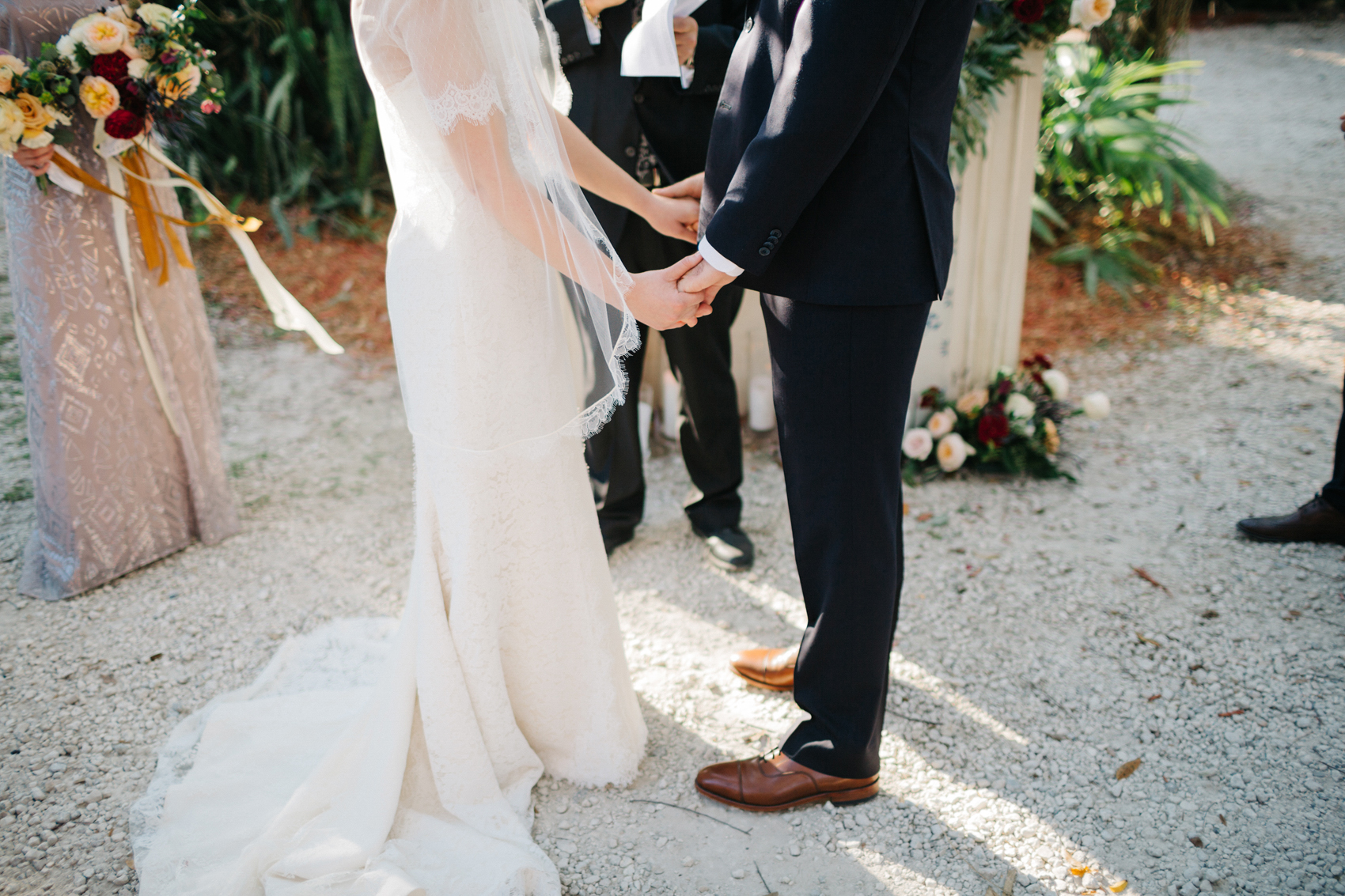 Bride and groom holding hands during the cermeony