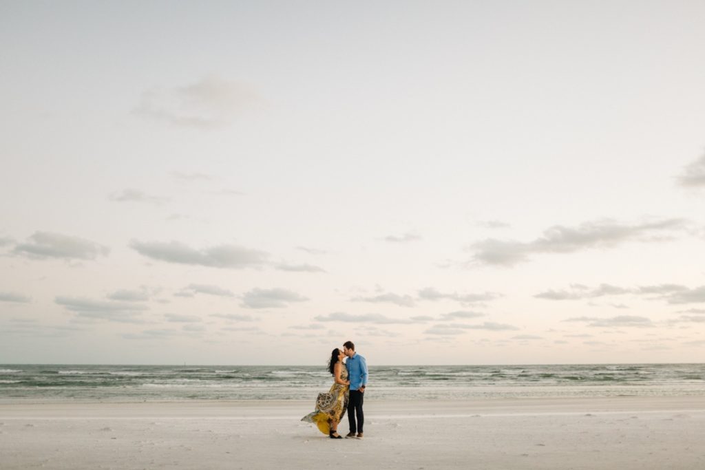 Windy beach engagement photos on Siesta Key Beach in Sarasota by Tampa wedding photographer Renee Nicole Photography