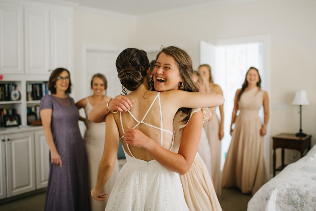 sweet first look with bridesmaids and friends
