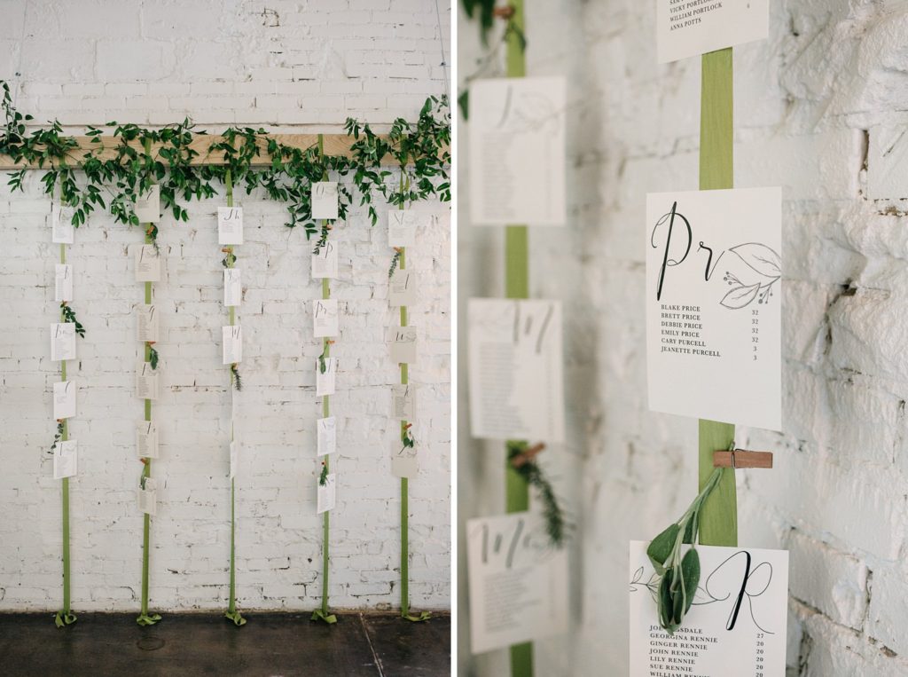 hanging seating chart with greenery and silk ribbon