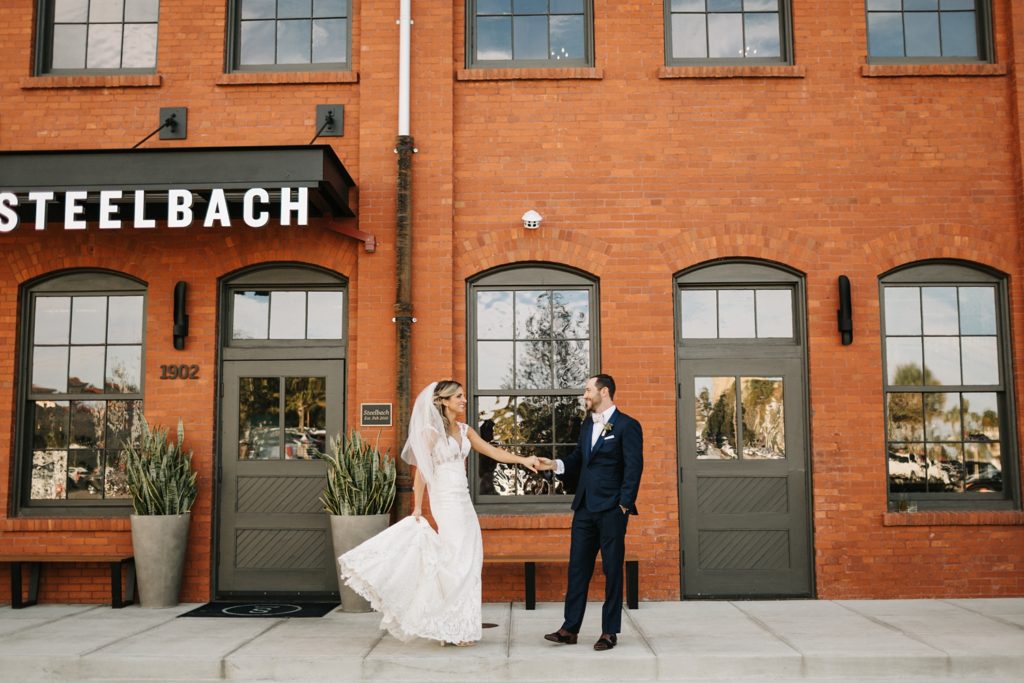 Modern wedding photography at industrial venue Armature Works in Tampa with exposed brick
