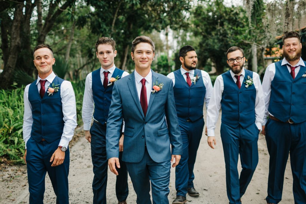 groomsmen wearing modern blue suits