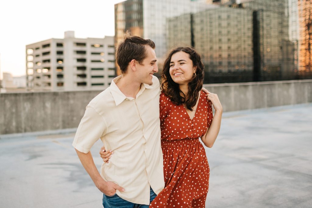 Candid lifestyle engagement session photos with the Tampa skyline in the background