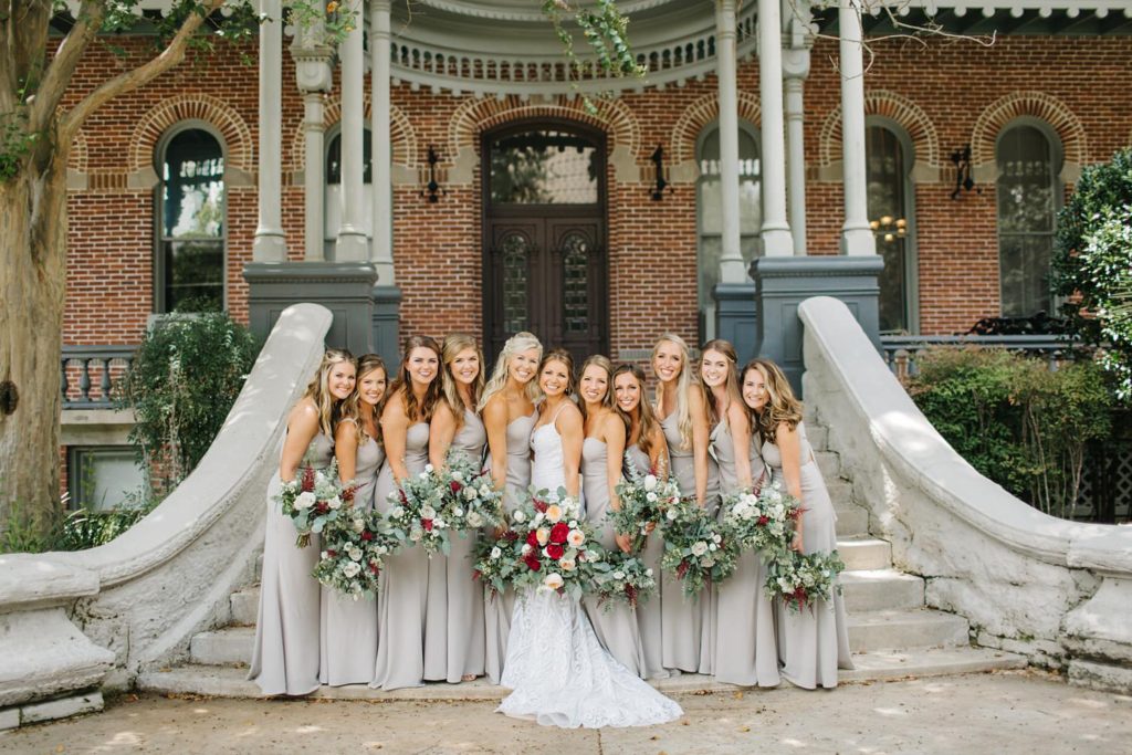 bridesmaids wearing jenny yoo dresses with lush bouquets of greenery and garden roses