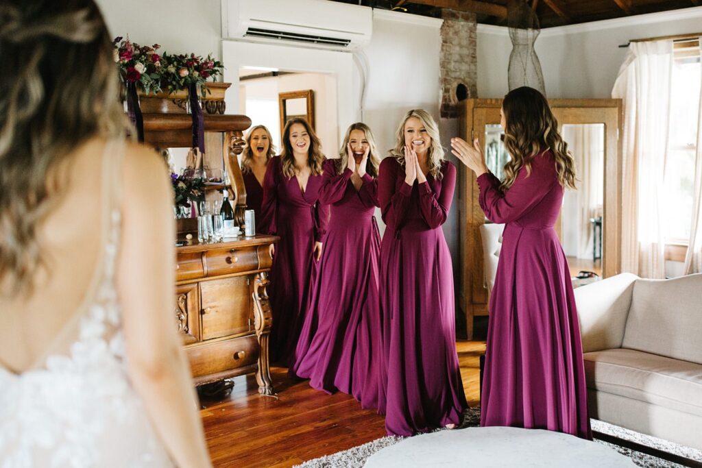 bridesmaids wearing plum dresses from lulus having a first look with the bride