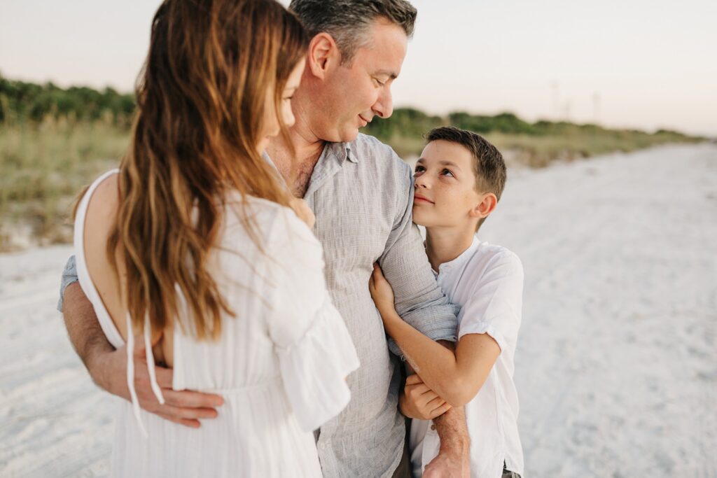 Sweet candid family photos on the beach by St. Pete family photographer