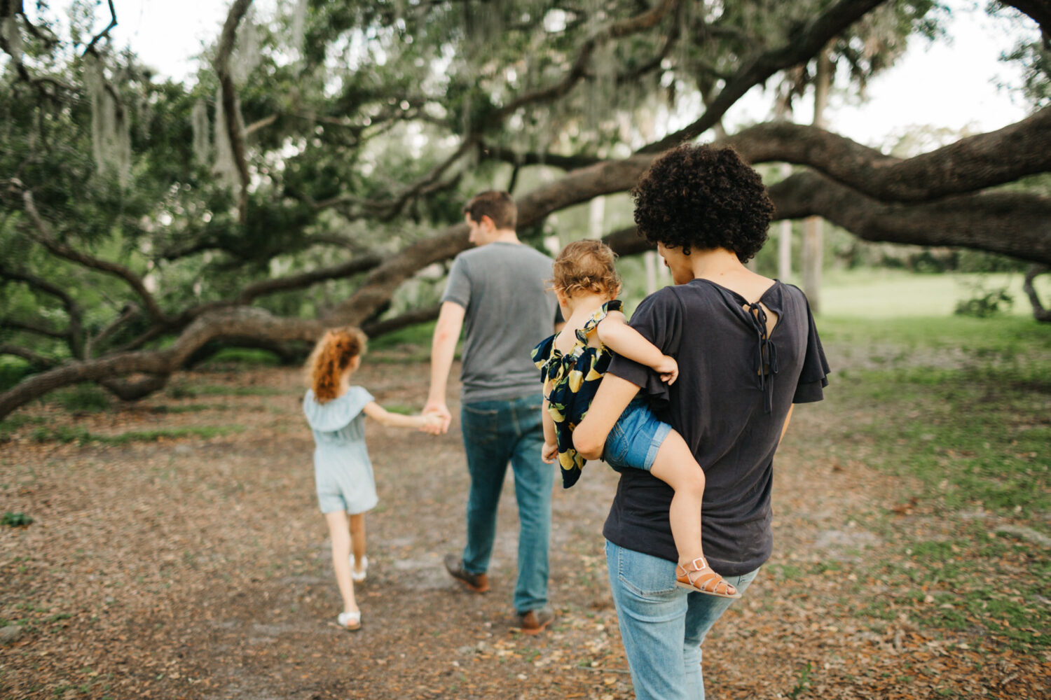 family walking under a big oak tree