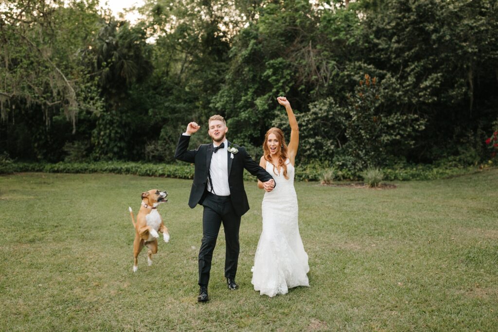 Bride and groom celebrating their wedding day with their dog