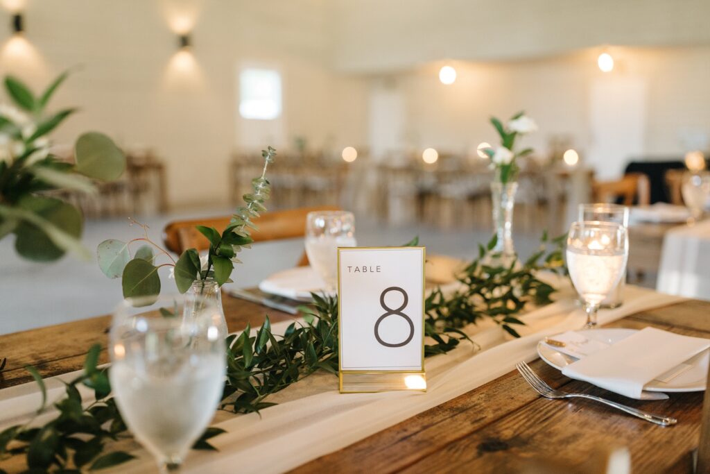classic rustic wedding decor with candles and greenery 