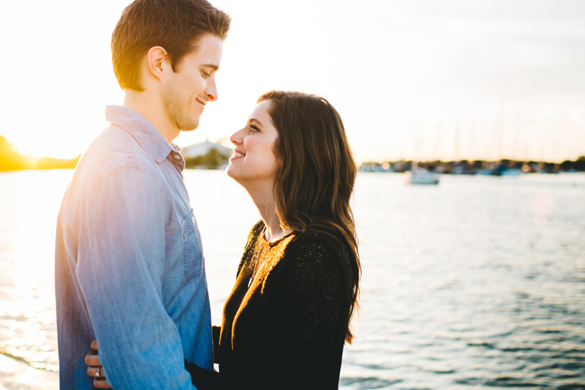 Happy couple on the beach during a romantic sunset engagement session