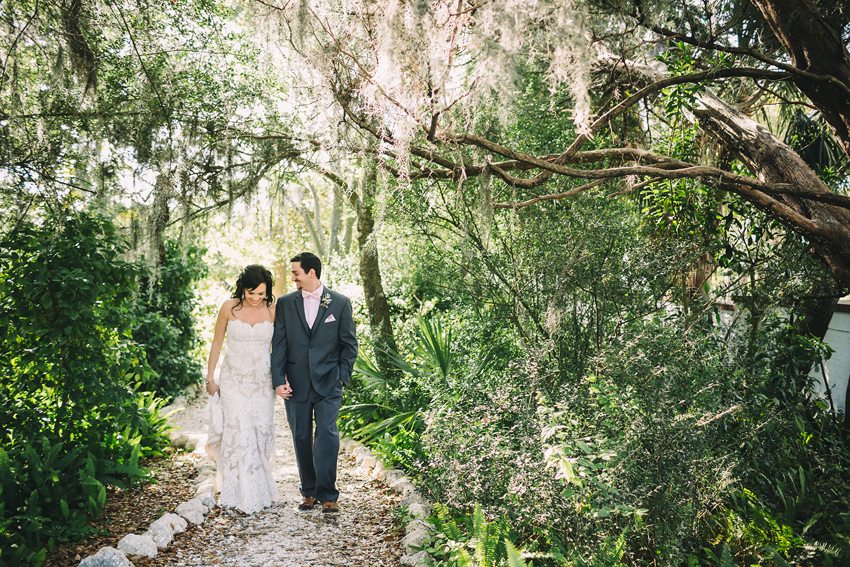 Bride & Groom walking along a secret garden pathway at Marie Selby Gardens in Sarasota, Florida