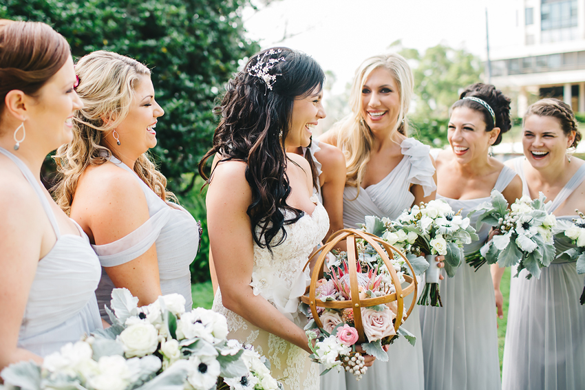 Bride laughing with bridesmaids before the garden ceremony at Marie Selby Gardens in central Florida