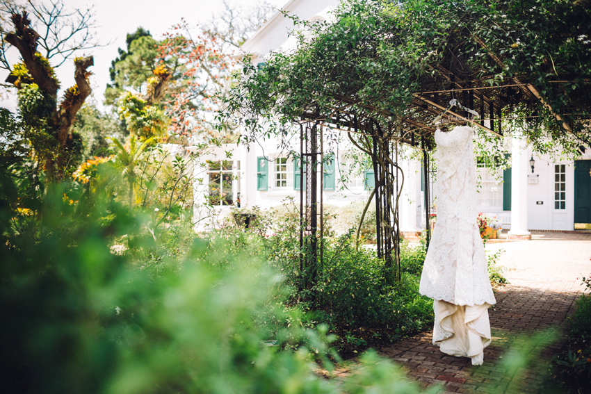 Anne Barge lace wedding gown hanging in the gardens at Marie Selby Gardens
