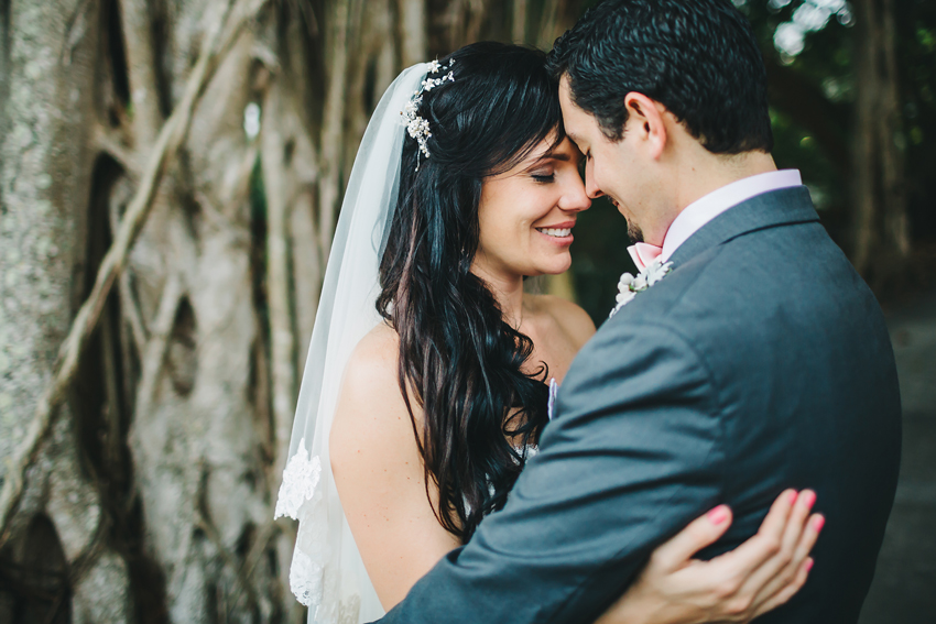 Happy bride & groom under the banyon trees at Marie Selby Gardens