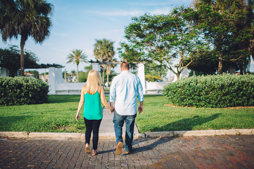 Sunny engagement session in downtown St. Pete with palm trees and brick roads