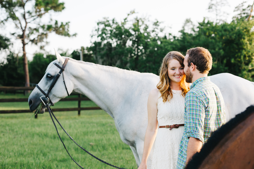 Engagement session photos with a beautiful white horse on a farm