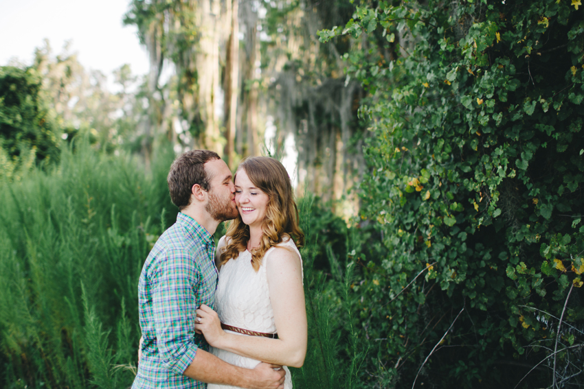 Engagement session kiss on the cheek pose