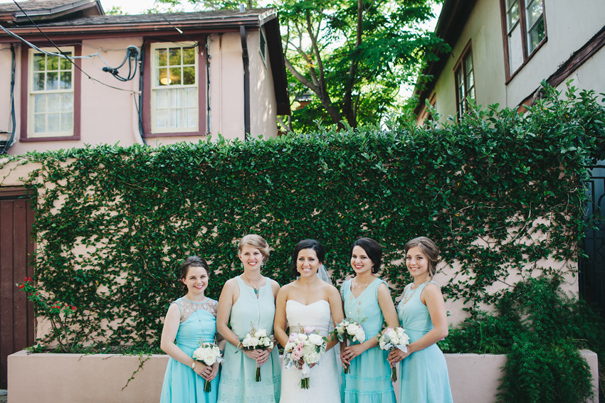 Teal bridesmaid dresses with peony and succulent bouquets