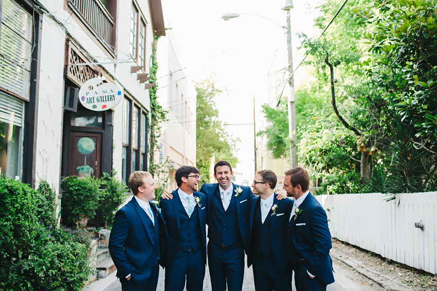 Groomsmen laughing and wearing stylish navy suits