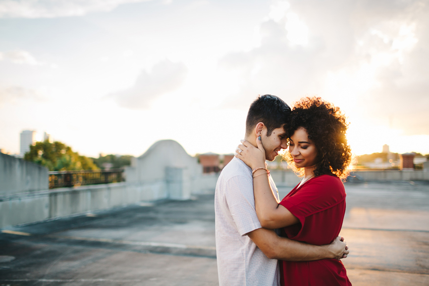 sunset engagement session photos on the rooftop of a parking garage in ybor city, florida