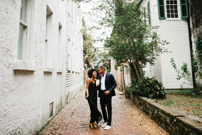 romantic and fun engagement session photos at stolls alley in downtown charleston