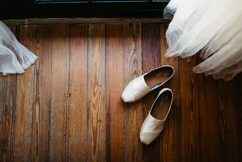 ivory toms wedding shoes on a wooden floor