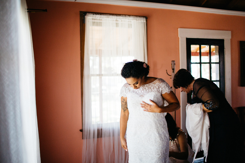 Bride getting ready next to the natural window light in the Acre bridal suite