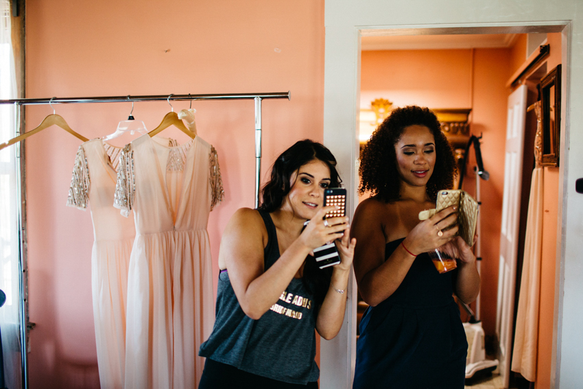 bridesmaids taking selfies while getting ready