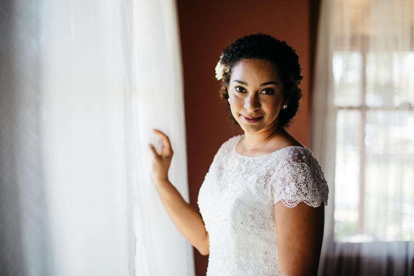 Creative bridal portraits next to the window at The Acre orlando