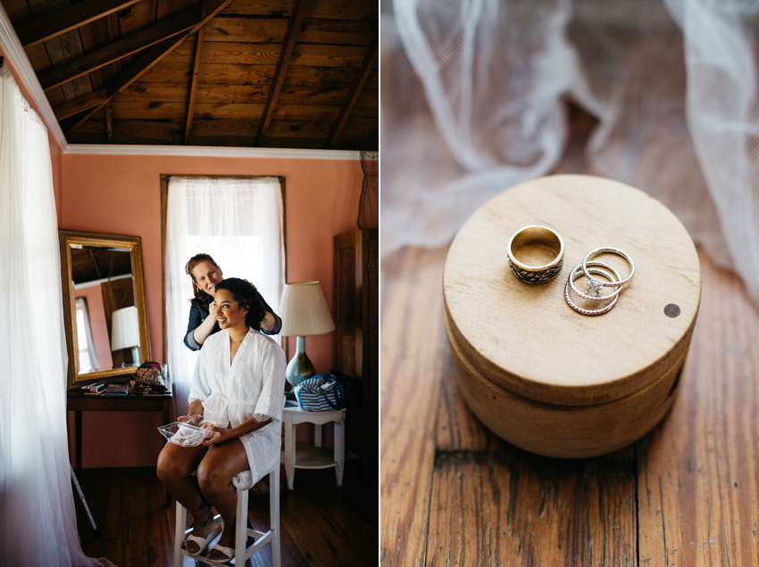 bride getting flowers in her hair and a closup of her wedding rings on a handmade wooden box