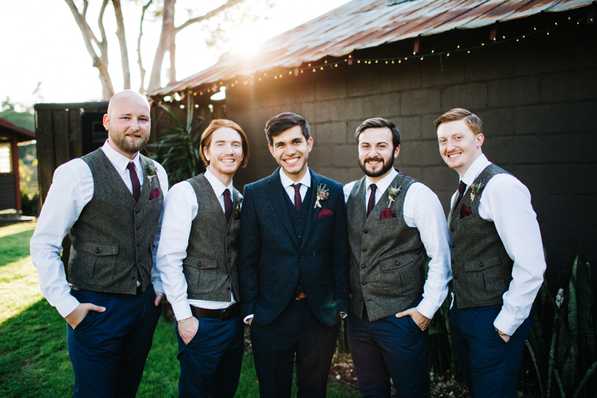 Groomsmen at sunset in tweed suit and vests with mini succulent boutonnieres
