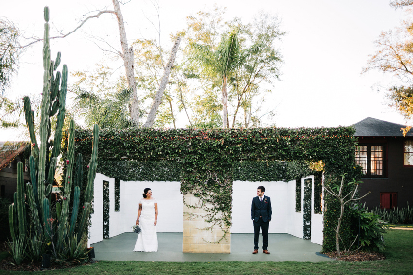Natural and creative wedding photography in front of the ivy cover brick building at the acre outdoor wedding in Orlando Florida