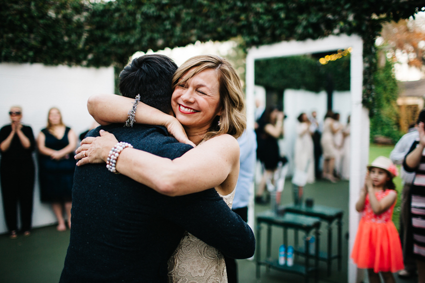 groom hugging his mom after the dance outside at The Acre