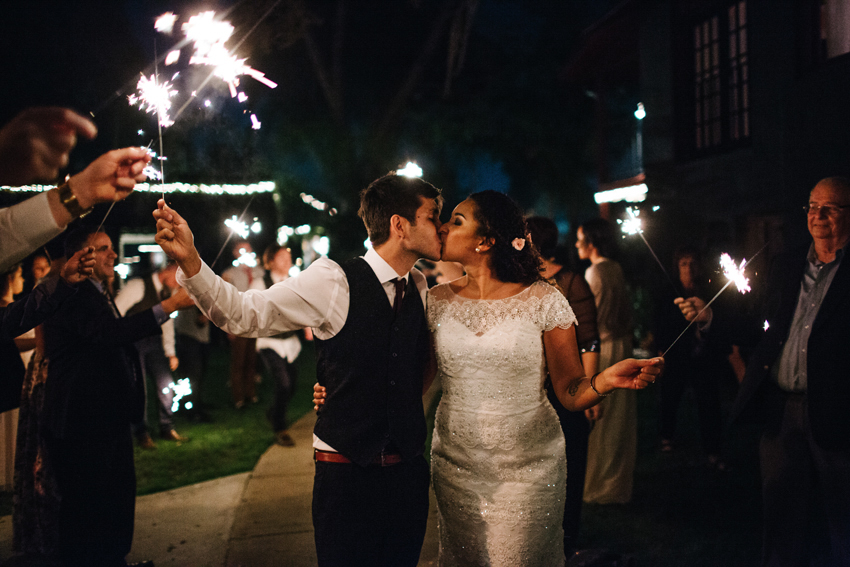 bride and groom kissing during their sparkler exit at The Acre
