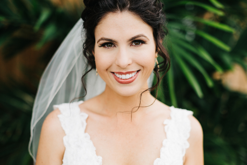 Gorgeous bride wearing a lace Maggie Sottero wedding gown for a romantic beachside wedding at the eclectic Postcard Inn in St. Pete, Florida