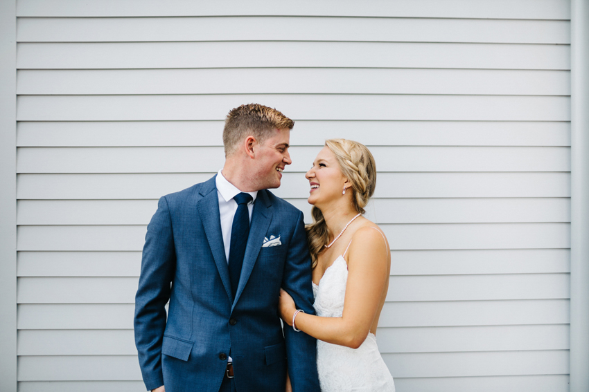 Natural candid wedding photos of the bride and groom laughing in Newport by destination wedding photographer Renee Nicole Photography