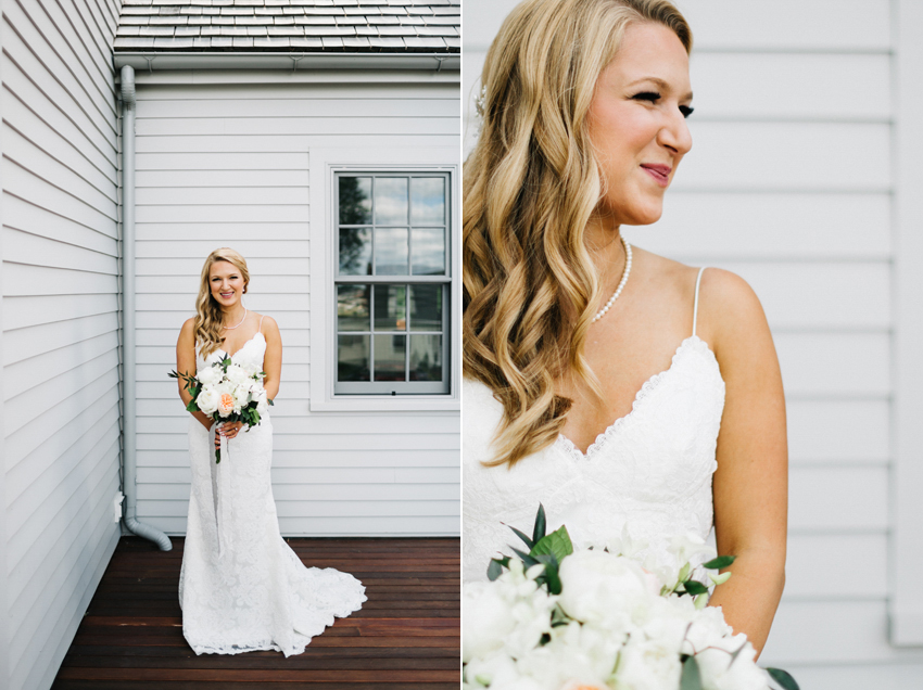 Bride wearing a stunning open back lace dress with a side braid and romantic wave hair style
