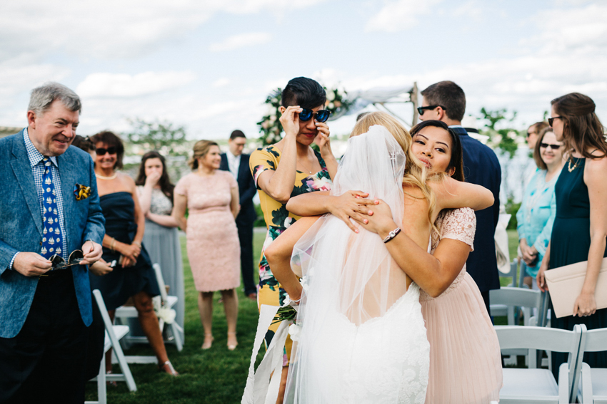 Candid photography of guests hugging after the ceremony by destination photographer Renee Nicole Photography