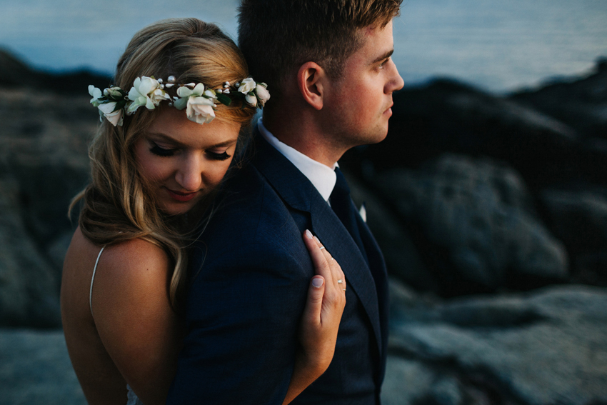 Romantic and creative wedding elopement photos with a boho bride wearing a flower crown at sunset on the cliff walk in New Port, Rhode Island by Renee Nicole Photography
