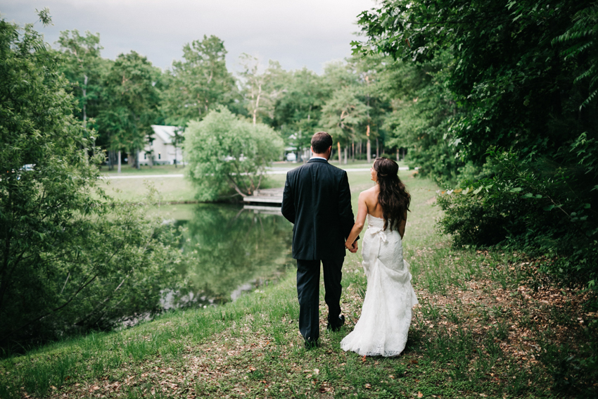 Bride and groom walking along the lake at the Pepper Plantation in Charleston wedding