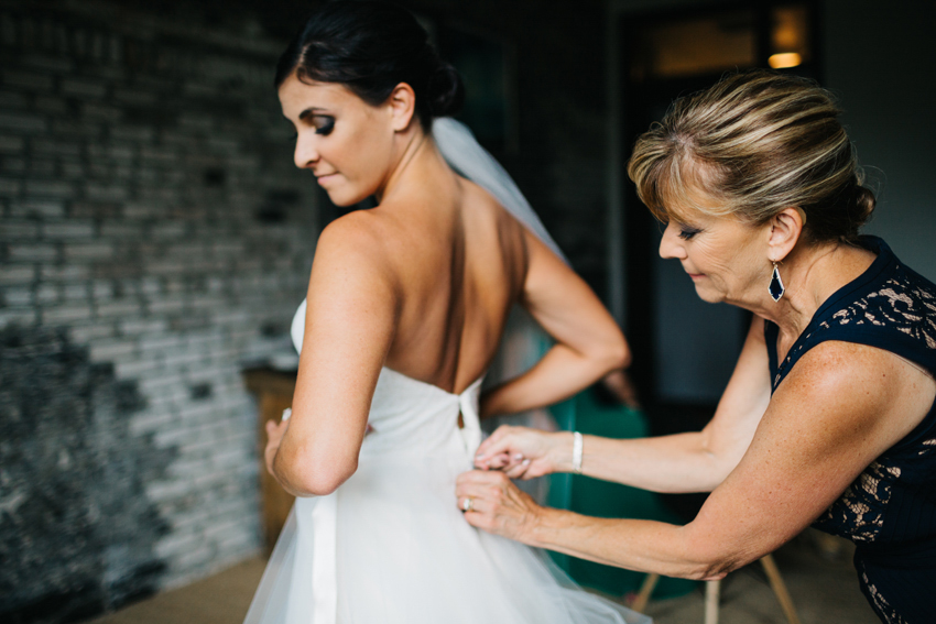 Mother of the bride helping her daughter get ready in the bridal suite at The Oxford Exchange