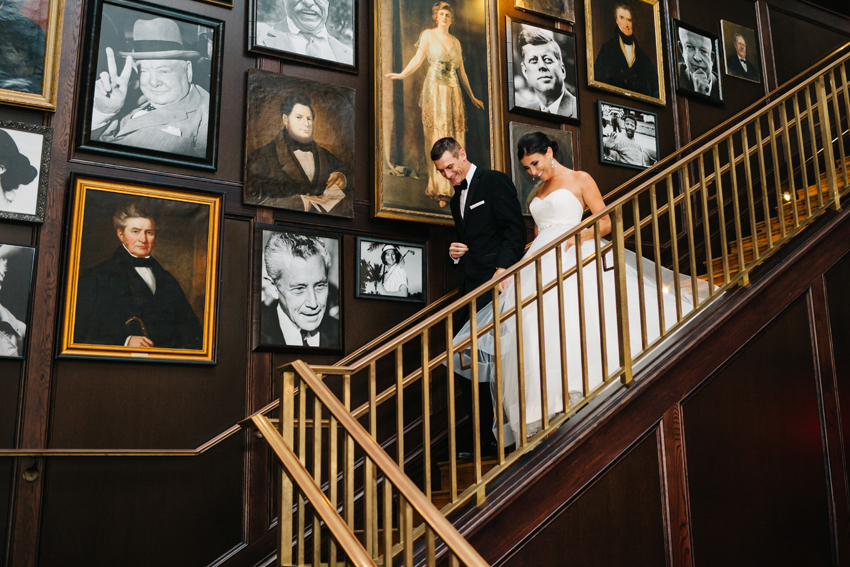 bride and groom making their grand entrance down the stairs at the Oxford Exchange