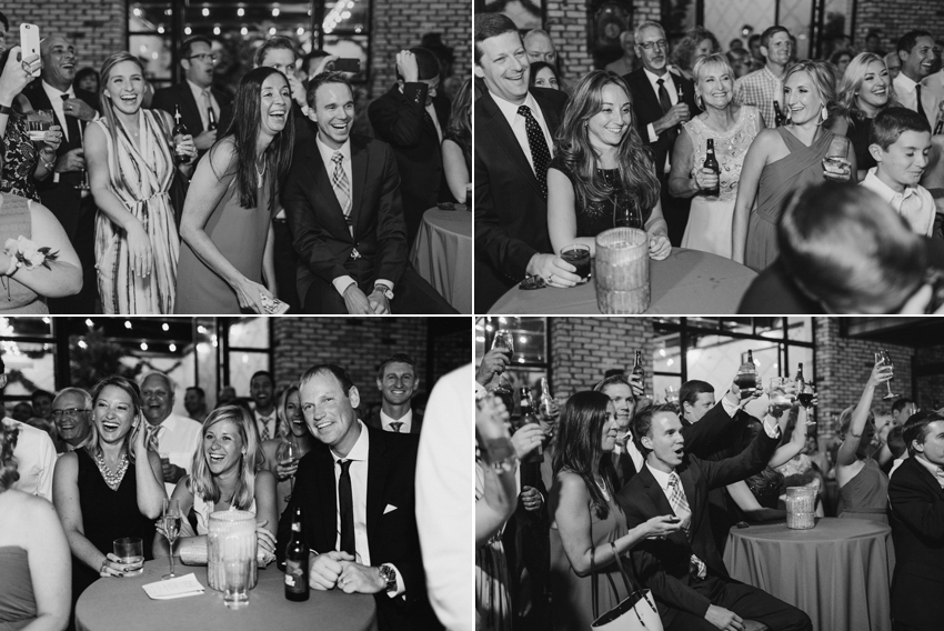 Candid wedding photography of guests laughing and toasting during the industrial reception at the Oxford Exchange